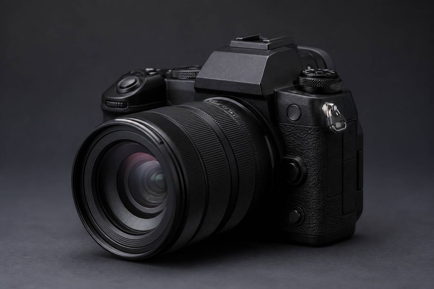 DSLR camera with wide-angle lens on a dark studio surface